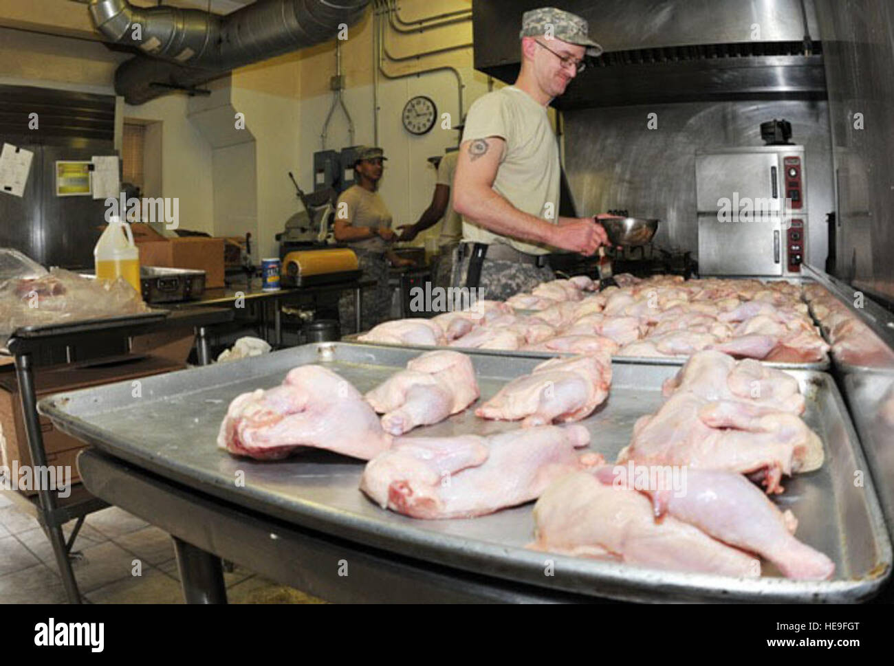 U.S. Army Pfc. Scott Larson, a food services specialist with the 82nd Airborne, preps Cornish game hen for dinner at the dining facility inside the Combined Joint Task Force-82 Joint Operations Center, Feb. 12.  A native of Butte, Neb., Larson and his team mates serve more than 900 meals per day at the dining facility inside of the Combined Joint Task Force-82 Joint Operations Center. During the holidays, the dining facility crew members plan for more elaborate festivities and spend extra hours to prepare those special meals. Stock Photo
