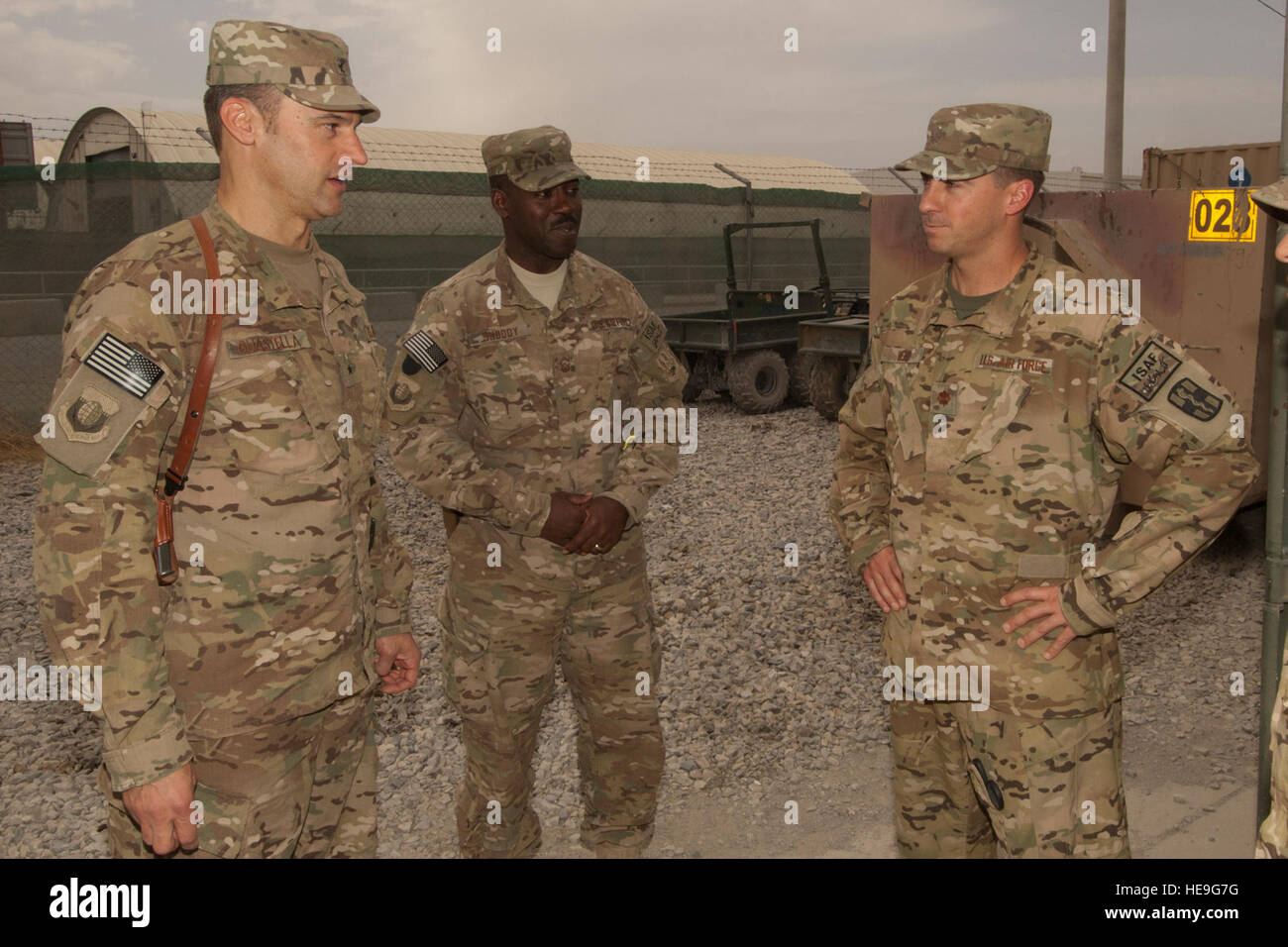 Brig. Gen. Joseph Guastella, commander 455th Air Expeditionary Wing, and 455 AEW Command Chief, Command Sgt. Marcus Snoddy, speak with Maj. James Webb, a Critical Care nurse assigned to the U.S. Army's 966th Forward Surgical Team, Task Force-Medical Alpha, prior to Webb's Purple Heart presentation at Bagram Air Field, Afghanistan, Aug. 28, 2012. Webb was serving as part of the medical evacuation crew in the central Ghazni province of Afghanistan when he was shot by an enemy AK-47 while loading a patient aboard his helicopter. Stock Photo