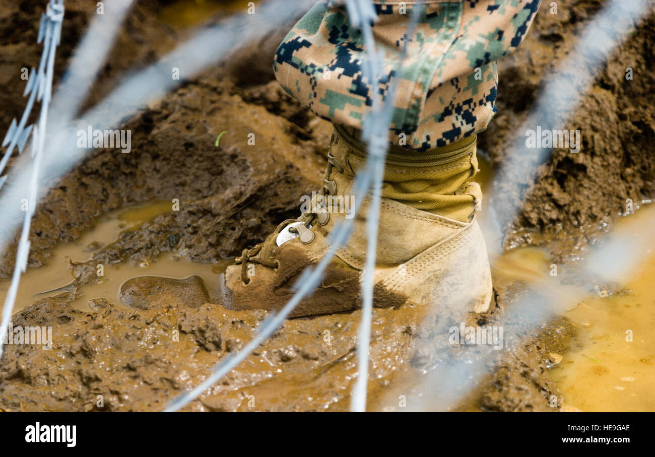 A U.S. Marine, from the Special-Purpose Marine Air-Ground Task Force-Crisis Response-Africa, helps to set up concertina wire during Operation United Assistance here, Oct. 20, 2014. The SPMAGTF Crisis Response-Africa is a self-sustaining crisis response unit, which capabilities include embassy reinforcement, support to non-combatant evacuation operations, tactical recovery of aircraft and personnel, humanitarian assistance, and disaster relief. Staff Sgt. Gustavo Gonzalez/) Stock Photo