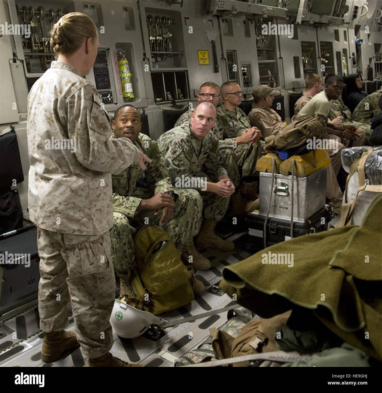 U.S. Marine Corps Sgt. Maj. Bonnie Skinner, Combined Joint Task Force-Horn of Africa command senior enlisted leader, speaks with Naval Mobile Construction Battalion (NMCB) 133 Detail Horn of Africa Seabees on board a C-17 Sept. 19, at Camp Lemonnier, Djibouti. Fifteen Seabees from NMCB-133 will travel to Monrovia, Liberia, in support of Operation UNITED ASSISTANCE to conduct site surveys, construct a $22 million hospital and stockpile it with supplies to support training of healthcare workers fighting the Ebola outbreak.  Staff Sgt. Leslie Keopka Stock Photo