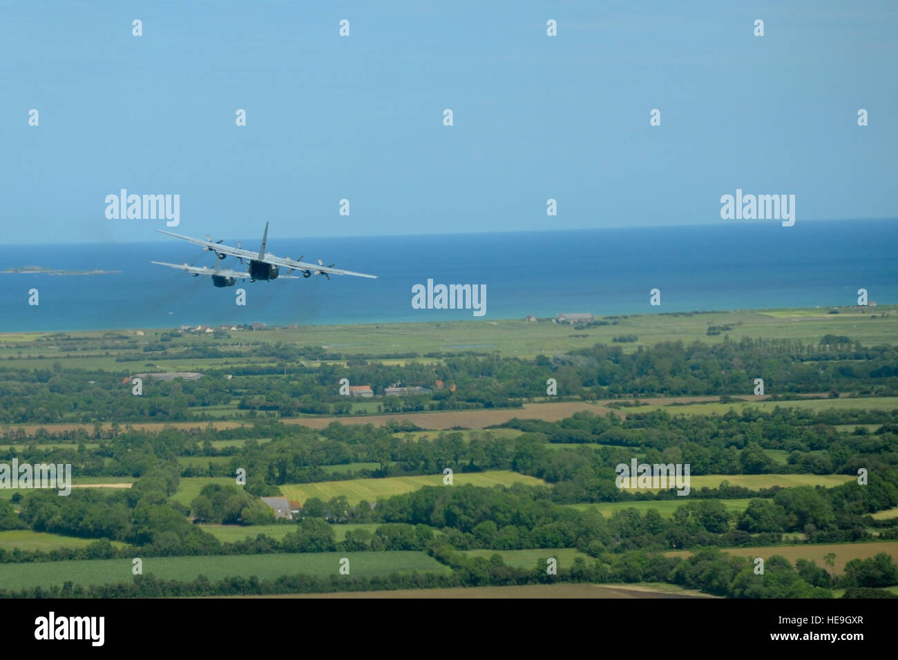 U.S. Air Force Reserve, Guard and active duty C-130H and C-130J Hercules aircraft crews from U.S. bases worldwide approach the beaches of Normandy, France as part of a commemorative flyover event on June 5, 2014. The flyover preceded a massive airdrop of over 1,000 paratroopers as part of the 70th anniversary commemoration of the D-Day landing in Normandy.  Tech. Sgt. Erica J. Knight Stock Photo