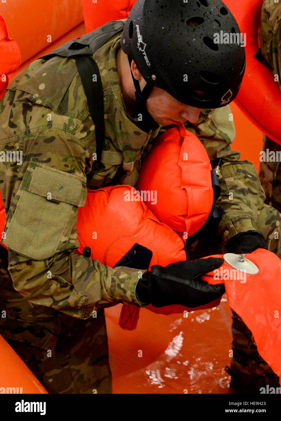 U.S. Air Force Senior Airman Seth Ewing, 352nd Special Operations Support Squadron Deployed Aircraft Ground Response Element team member from Front Royal, Va., examines a life preserver on an F-2B 20-man life raft during a Survival, Evasion, Resistance and Escape exercise Feb. 26, 2015, at Lowestoft College in Norfolk, England. SERE specialists conduct monthly water survival training to keep required Airman up-to-date on current requirements and protocols.  Senior Airman Victoria H. Taylor Stock Photo