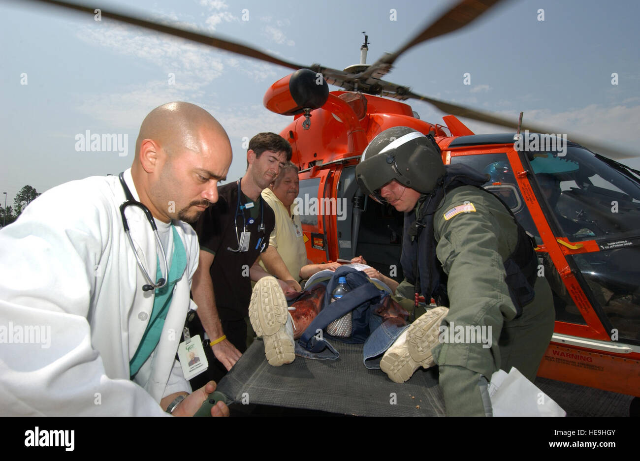 050524-F-5586B-129  Hospital personnel offload an simulated patient on a stretcher from a U.S. Coast Guard HH-65 Dolphin helicopter at Garden Park Medical Center in Gulfport, Miss., on May 24, 2005, during Exercise Lifesaver 2005.  The exercise is a Homeland Security/National Disaster Medical System exercise being conducted in eight states, coordinating efforts between military, local, state and federal agencies.  The exercise scenario is based on an oil refinery explosion involving more than 200 patients.   Master Sgt. James M. Bowman, U.S. Air Force. (Released) Stock Photo