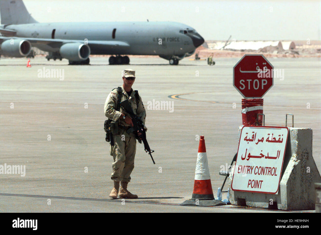 960904-F-0954H-004 Security Policeman Airman 1st Class Chris Culross stands guard at the Flightline Entry Control Point at Prince Sultan Air Base, Al Kharj, Saudi Arabia, on Sept. 4, 1996. The security police contingent at Al Kharj has established a single entry point for all vehicles as security measure which allows for tighter control of vehicle movement on and off the flightline.  Personnel, aircraft, and equipment conducting Operation Southern Watch are being moved from bases in Dhahran and Riyadh to the remote desert air base to reduce their vulnerability to terrorist attack.  Southern Wa Stock Photo
