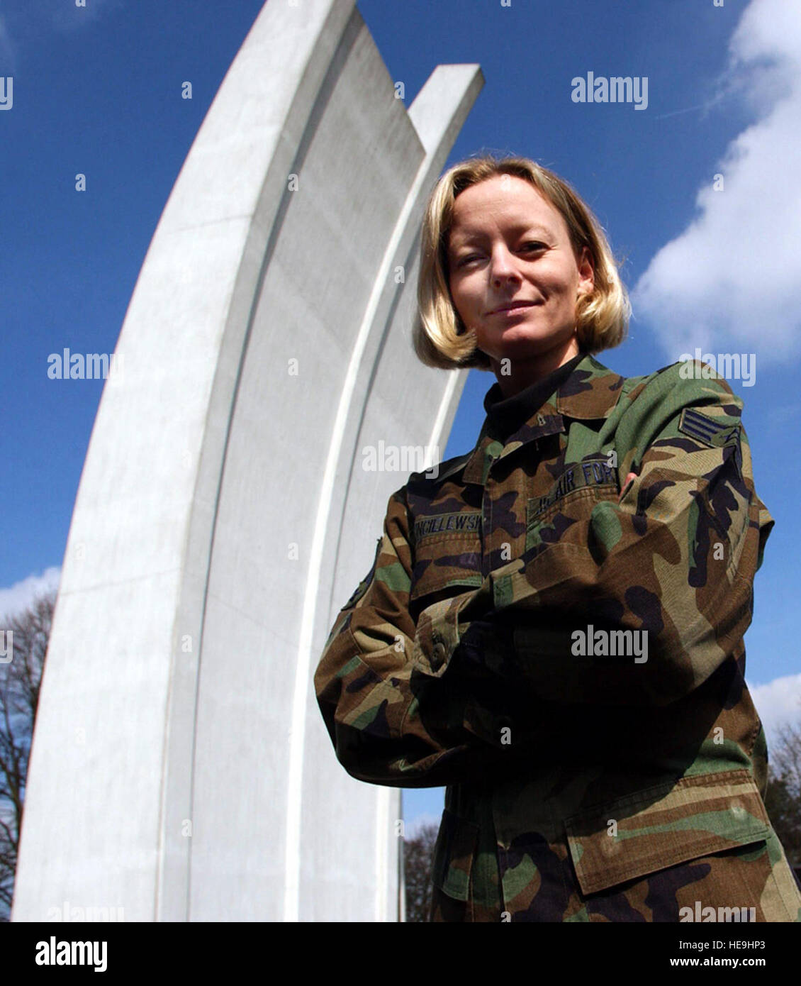 RHEIN-MAIN AIR BASE, Germany -- Senior Airman Anke Dzincielewski pauses near the Berlin Airlift Memorial here.  Dzincielewski grew up in East Germany and remembers life before the Berlin Wall came down.  She is deployed here from Ellsworth Air Force Base, S.D.   Master Sgt. Keith Reed) Stock Photo