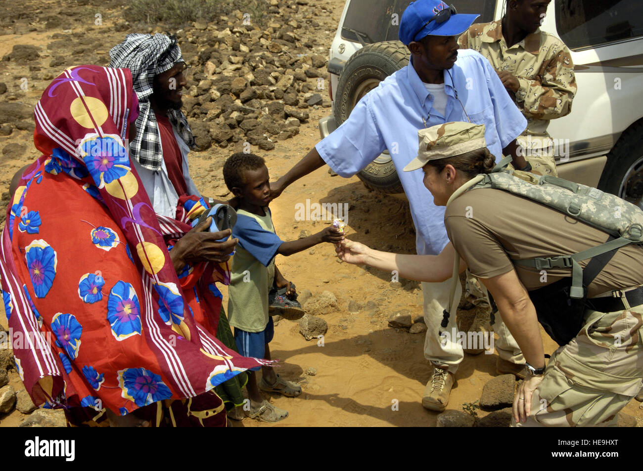 U.S. Navy Lt. Cmdr. Wendy Halsey hands out candy to local children