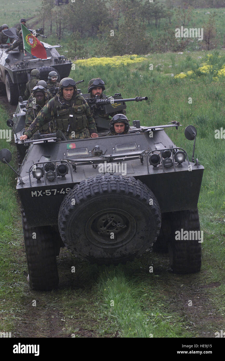 During exercise Iberian Resolve, Portuguese soldiers from the 2nd Armored Division use Chaimite V200 Armored Personnel Carriers to steer their way through the impact target area on the Glamoc live-fire range in western Bosnia, June 2, 2002.  On this day for more than an hour, the Portugese soldiers worked in conjunction with a pair of U.S. Army OH-58D helocopters to engage a series of large rectangular targets on a far hillside using Milan anti-tank missiles, Browning 50 cal machine guns, and shoulder mounted sniper rifles.  The objective of exercise Iberian Resolve is to integrate Multination Stock Photo