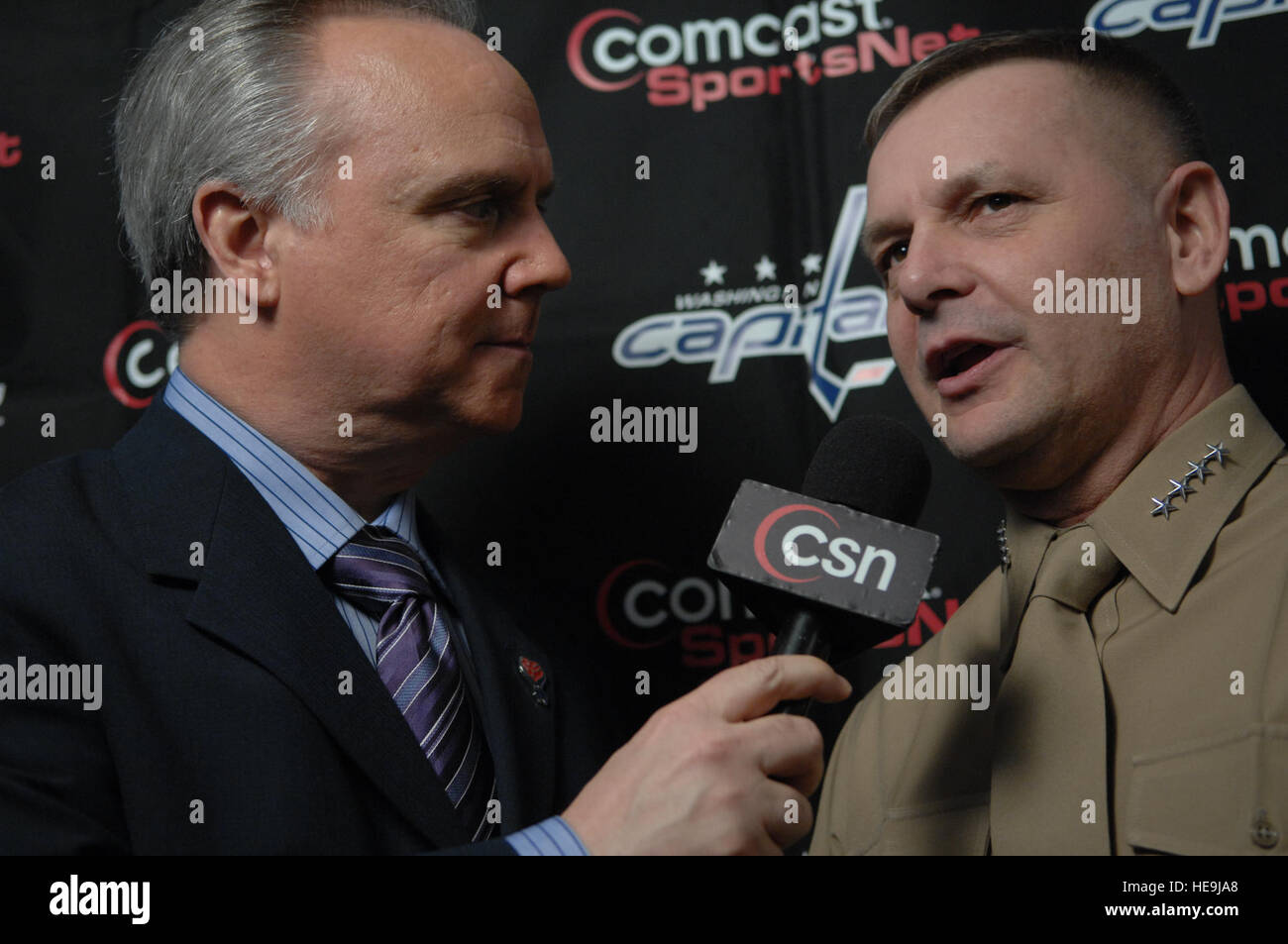 Marine Corps Gen. James E. Cartwright, vice chairman of the Joint Chiefs of Staff, gives an interview to Comcast SportsNet broadcaster Al Koken during the Washington Capitals' "Salute to the Troops" game at the Verizon Center in Washington, D.C., Feb. 20, 2008.  Cartwright and other senior defense officials watched as the Capitals lost in a shootout to the New York Islanders, 3-2.  Air Force Tech. Sgt. Adam M. Stump. (Released) Stock Photo