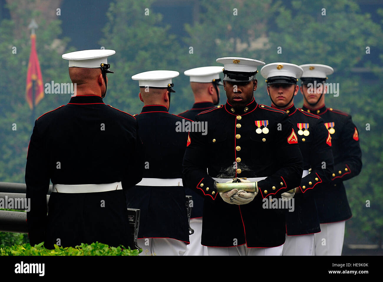 Marines from the Body Bearers Section, Bravo Company, hold the last smoking shells from a saluting battery at the farewell tribute for Joint Chiefs of Staff Vice Chairman Gen. James E. Cartwright at the Marine Corps Barracks, Washington, D.C., Aug. 3, 2011.  Tech. Sgt. Jacob N. Bailey, U.S. Air Force Stock Photo