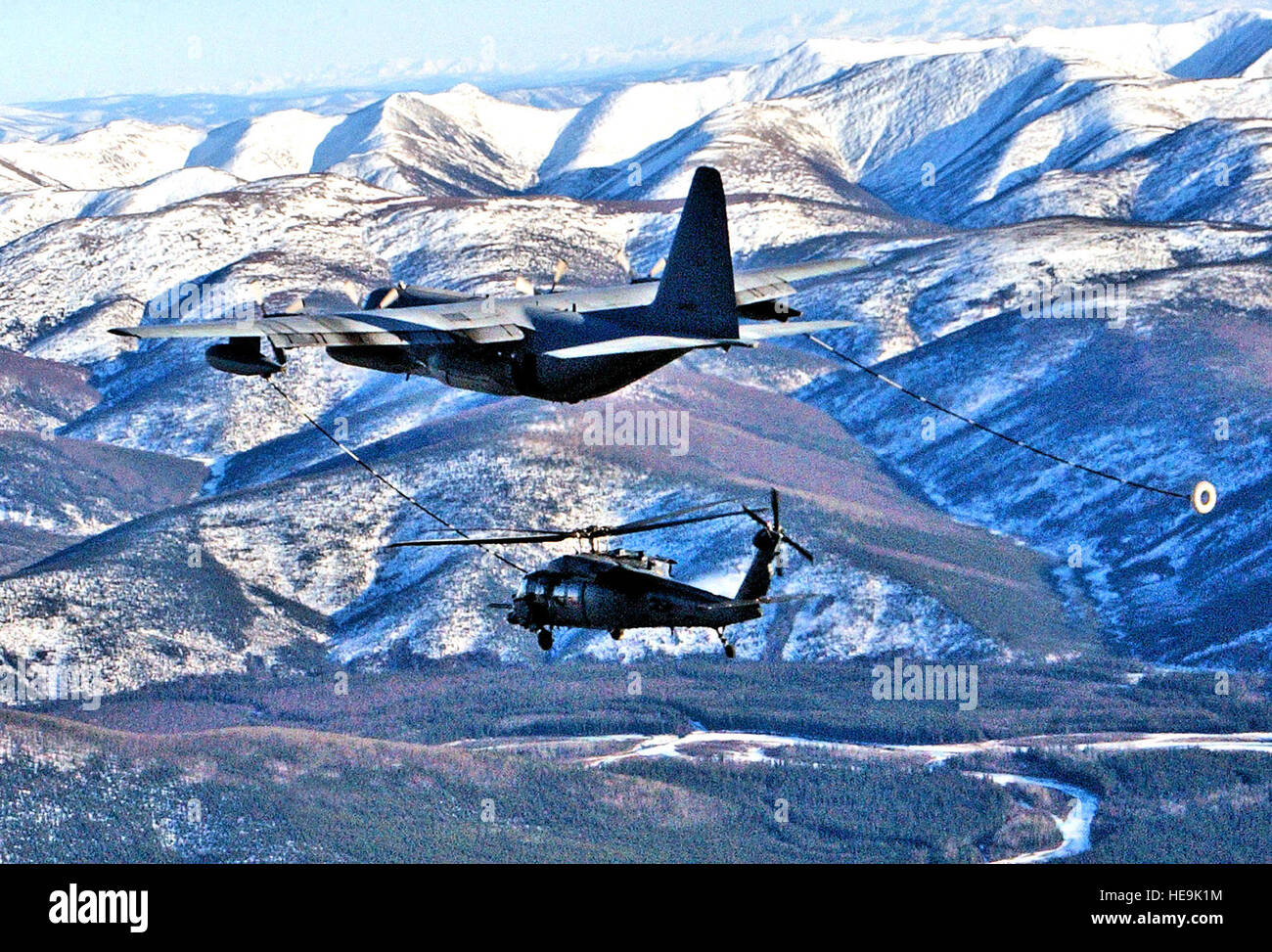 An HC130 Hercules refuels an HH60G Pave Hawk helicopter April 17