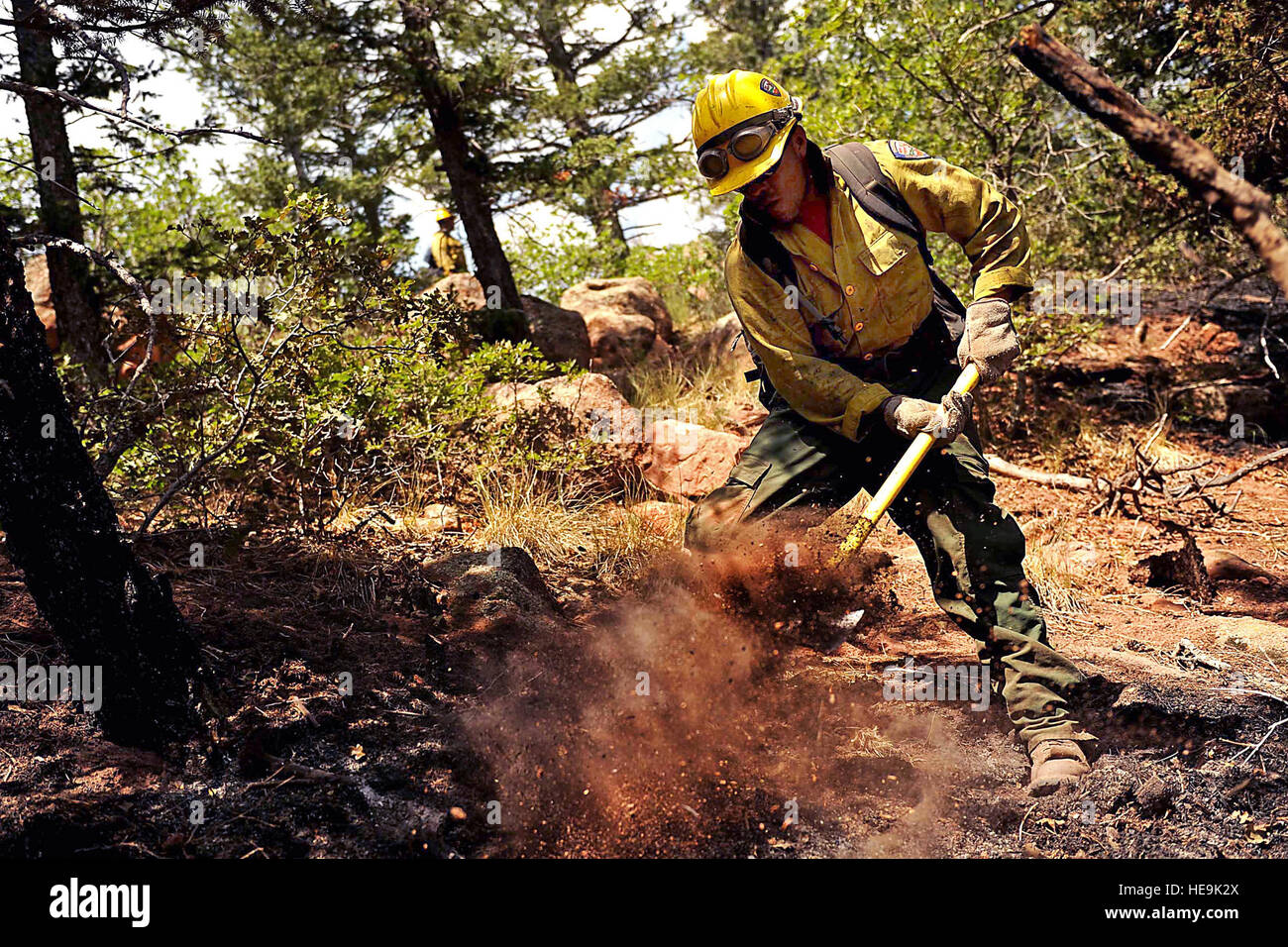 Vandenberg Air Force Base Hot Shot fire fighter Lupe Covarrubias cuts a fire line on June 28, 2012 in the Mount Saint Francois area of Colorado Springs, Co. while helping to battle several fires in Waldo Canyon.  The Waldo Canyon fire has grown to 18,500 acres and burned over 300 homes. Currently, more than 90 firefighters from the Academy, along with assets from Air Force Space Command; F.E. Warren Air Force Base, Wyo.; Fort Carson, Colo.; and the local community continue to fight the Waldo Canyon fire.(: Master Sgt. Jeremy Lock) (Released) Stock Photo