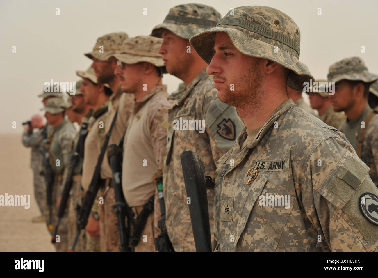 U.S. Airmen, Soldiers, Sailors and Marines stand in formation prior to