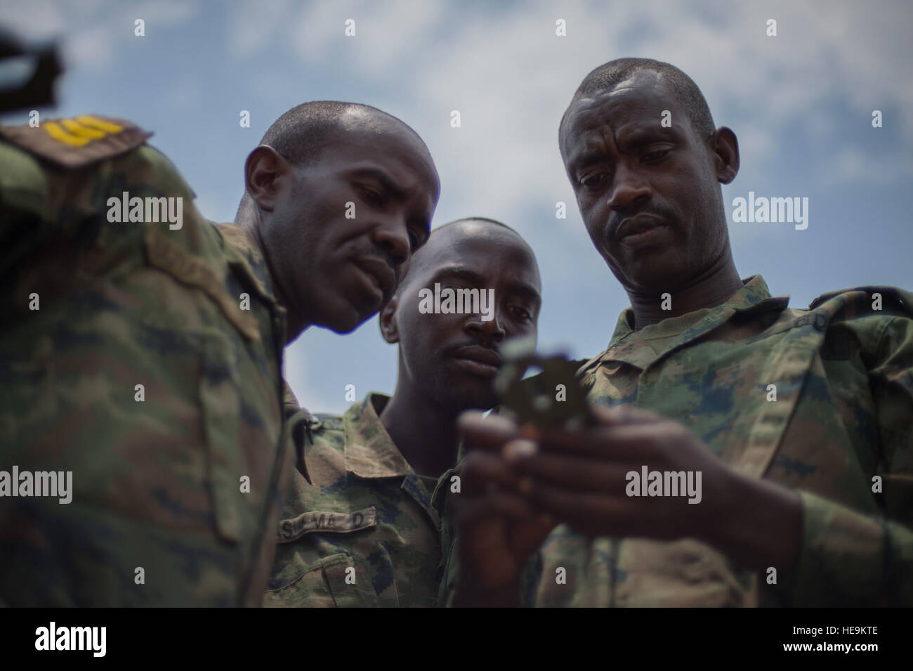Rwanda Defense Force noncommissioned officers use a compass to gather direction and heading during a land navigation portion of their NCO leadership training Sept. 8, 2016, at the Rwanda Military Academy, Rwanda.  Members of 1st Battalion, 124th Infantry regiment, who are deployed from the Army National Guard to Combined Joint Task Force - Horn of Africa, observed the NCO course to provide advice and critiques to improve the class.  Staff Sgt. Eric Summers Jr.) Stock Photo
