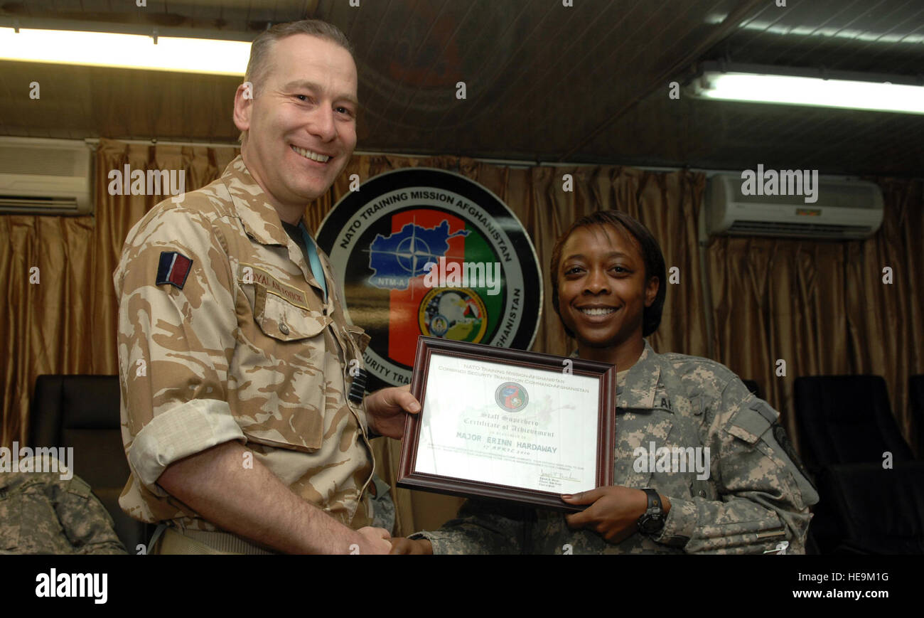 CAMP EGGERS, Afghanistan (17 April, 2010)--Maj. Erinn Hardaway is presented a Staff Superhero award at Chief of Staff meeting for her hard work and dedication to the NATO Training Mission. Major Hardaway is the Personnel Information Management System program manager and travels around educating the Afghan National Army on the use of PIMS.  Staff Sgt. Jeff Nevison) Stock Photo