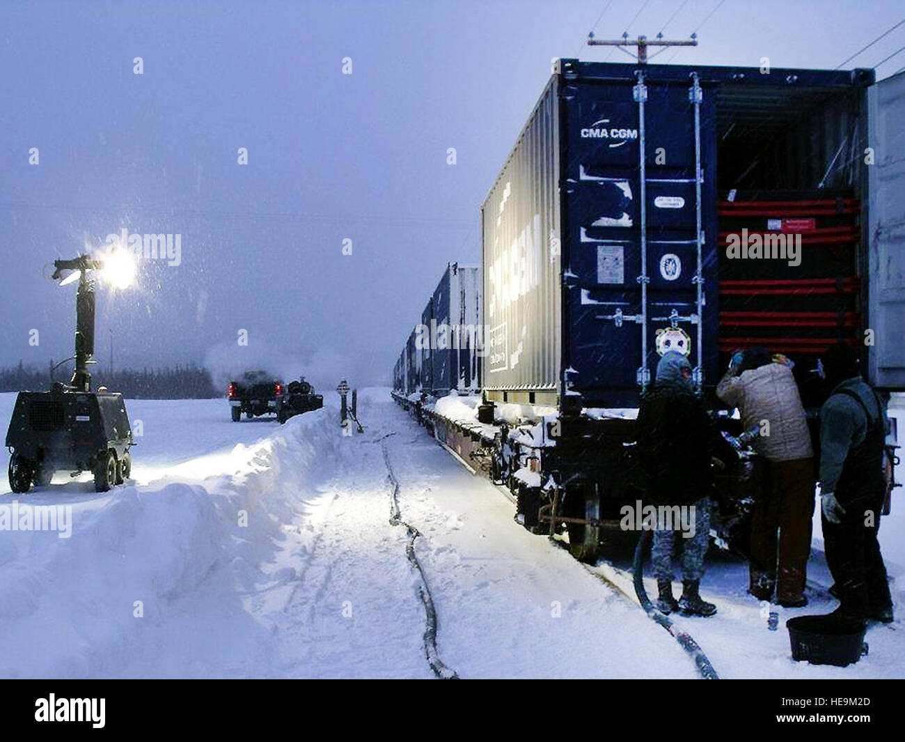 Airmen from the 354th Civil Engineer Squadron prepare flexi tanks for deicer fluid transfer at Eielson Air Force Base, Alaska. The operation ensures safe transport of specialized containers designed to prevent fluid sloshing during transit, supporting airfield maintenance and winter operations. Stock Photo