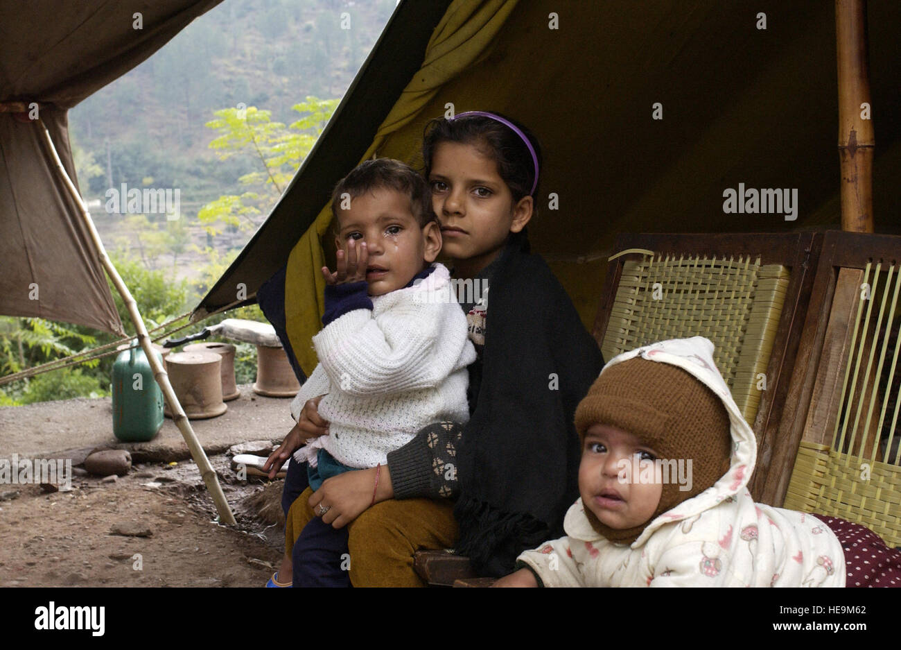 Young earthquake survivors live in a tent after their house was destroyed at Muzaffarabad, Pakistan, Nov. 11, 2005. The U.S. government is participating in a multinational humanitarian assistance and support effort lead by the Pakistani government to bring aid to victims of the devastating earthquake that struck the region Oct. 8, 2005.   Airman 1st Class Barry Loo Stock Photo