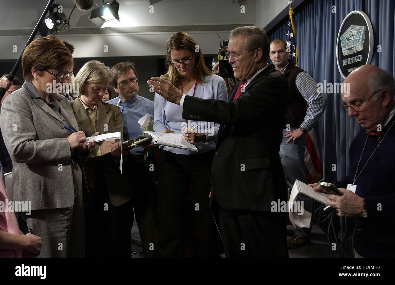 031216-F-2828D-391 Reporters surround Secretary of Defense Donald H. Rumsfeld as he answers another question at the conclusion of a Pentagon press conference on Dec. 16, 2003.  Rumsfeld and Vice Chairman of the Joint Chiefs of Staff Gen. Peter Pace, U.S. Marine Corps, updated reporters with the latest information on the December 13th discovery and capture of Saddam by the U.S Army’s 4th Infantry Division, U.S. Special Operations forces and coalition troops.   Tech. Sgt. Andy Dunaway, U.S. Air Force. (Released) Stock Photo