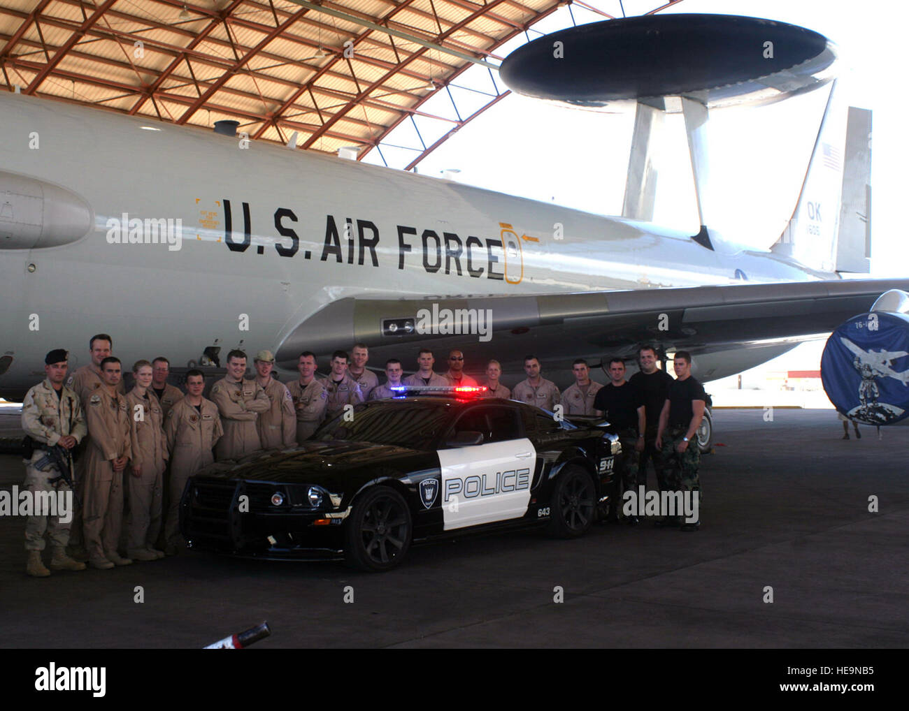 Members of Tinker's 552nd Air Control Wing and 72nd Security Forces Squadron pose with and E-3 Sentry aircraft and 'Barricade,' the police car Decepticon from 'Transformers: The Movie,' during filming at Edwards Air Force Base, Calif., September 2006.   Capt. Corinna Jones) Stock Photo
