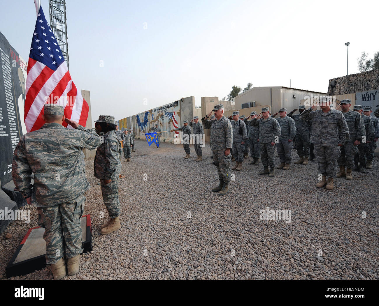 Members of the 727th Expeditionary Air Control Squadron (Kingpin) render a salute as the colors are raised during a memorial ceremony at Joint Base Balad, Iraq, May 13, 2010. Kingpin's annual ceremony was in honor of Staff Sgt. Patrick Lee Griffin Jr., a squadron warrior who was killed by an improvised explosive device as the 728th ACS convoyed from Kuwait to Baghdad, May 13, 2003. Kingpin executes tactical command and control for Operation Iraqi Freedom. Stock Photo