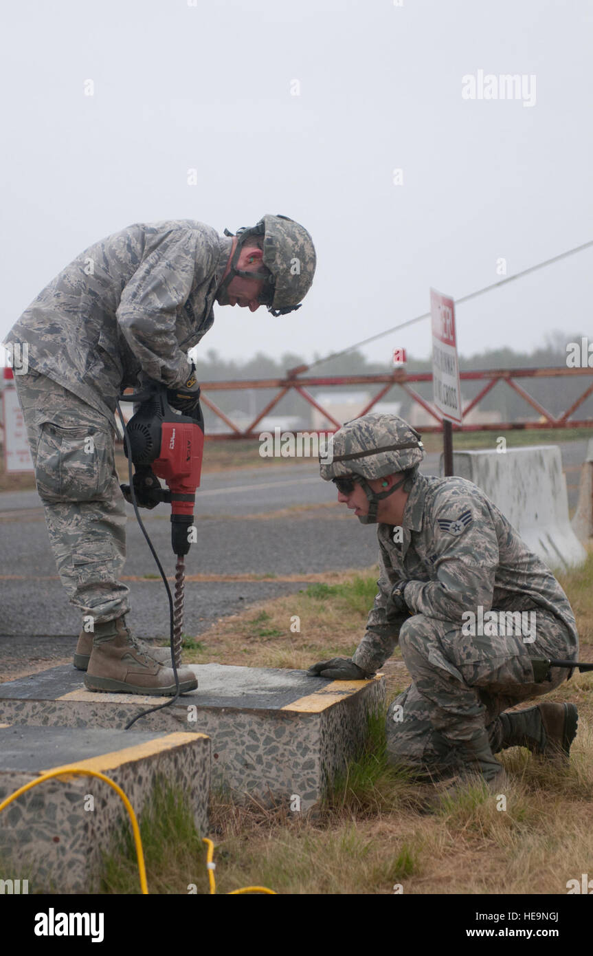 Civil engineers from a joint assessment team test slabs of concrete on the runway at Lakehurst Naval Air Engineering Station, N.J., to evaluate its strength prior to establishing a joint task force-port opening March 25, 2012. The Kentucky Air National Guard's 123rd Contingency Response Group from Louisville, Ky., and the 690th Rapid Port Opening Element from Fort Eustis, Va., joined forces to form the JTF-PO at an Eagle Flag exercise at Joint Base McGuire-Dix-Lakehurst, N.J., through March 30. Stock Photo