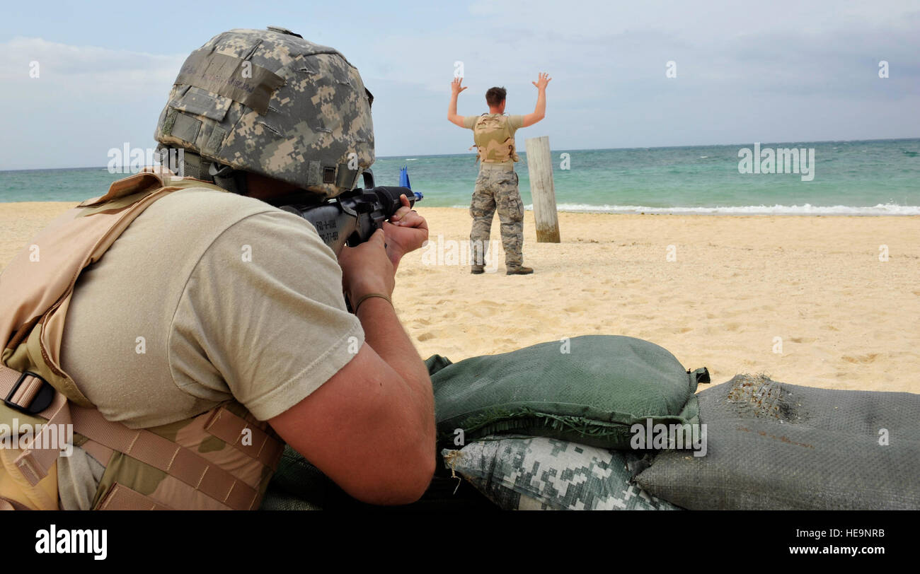 U.S. Air Force Senior Airman Jarrett Welton aims a rubber M16 A2 rifle