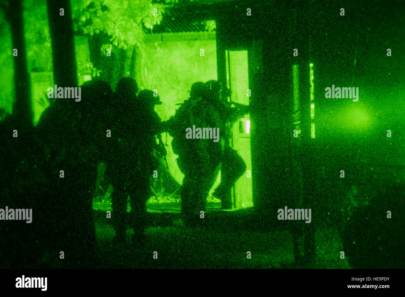 U.S. Army special forces Soldiers storm a house during Operation Serpent Catfish as part of Emerald Warrior 2013, John C. Stennis Space Center, Miss., May 1. During the operation, the Soldiers infiltrated a simulated hostile camp, eliminated the enemy threat and collected evidence as part of sensitive site exploitation. The primary purpose of Emerald Warrior is to exercise special operations components in urban and irregular warfare settings to support combatant commanders. Emerald Warrior leverages lessons from Operation Iraqi Freedom,Operation Enduring Freedom and other historical lessons to Stock Photo