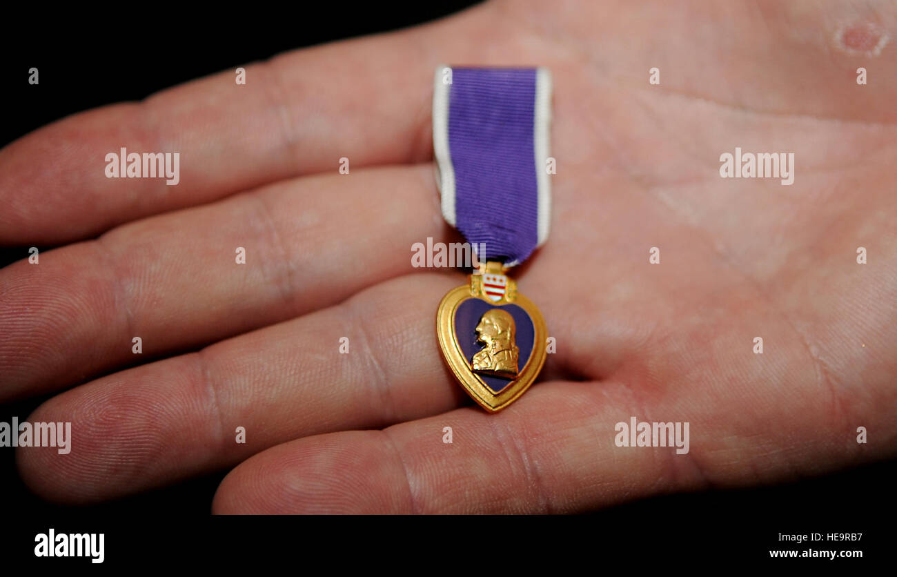 Paul Blais holds his Purple Heart medal in his hand May 15, 2013. Blais was awarded the medal after he survived the Khobar Tower bombing June 25, 1996.  Staff Sgt. Jarad A. Denton Stock Photo