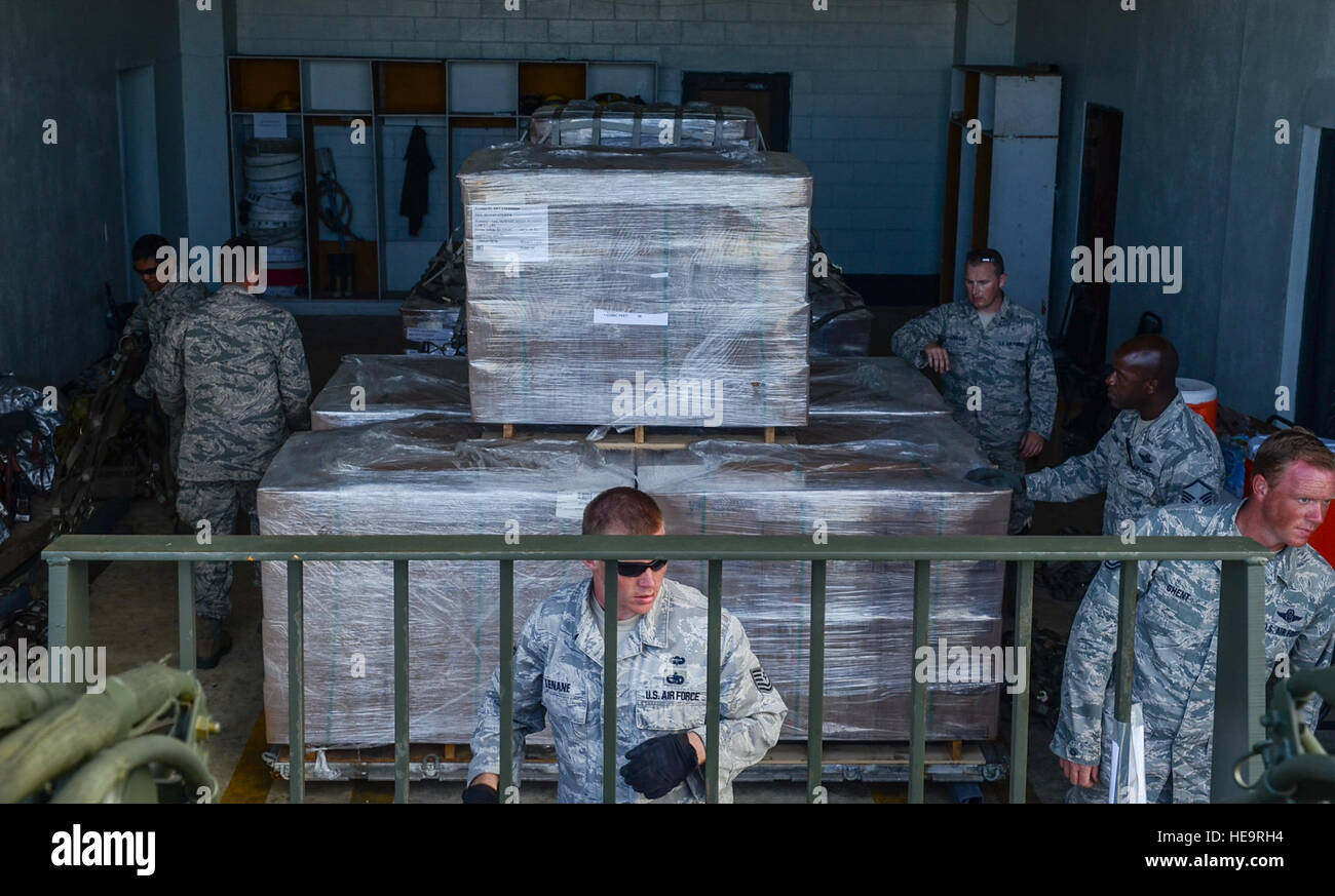 Airmen from the 36th Contingency Response Group prepare packages of humanitarian aid supplies on a pallet for individual transport at the Rota International Airport, Feb. 19, 2014. Airmen from the U.S. Air Force, Japan Air Self-Defense Force and Royal Australian Air Force participating in Cope North, a multi-lateral exercise on Andersen Air Force Base, Guam, transitioned from the scenario-based humanitarian assistance and disaster relief training of the exercise on Tinian to humanitarian assistance of food and commodities to the citizens of Rota when Gov. Eloy Inos declared Rota under a state  Stock Photo