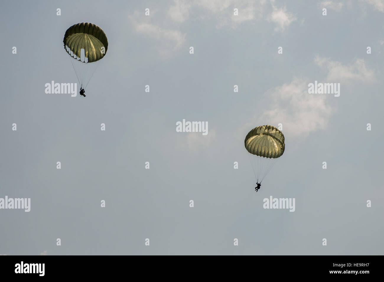 U.S. Air Force, Thai and Singaporean military conduct static and High Altitude Low Opening jumps from a U.S. C-130 during Exercise Cope Tiger 15 near Korat, Thailand, March 10, 2015. CT15 includes 22 total flying units and over 1,390 personnel from three countries and continues the growth of strong, interoperable and beneficial relationships within the Asia-Pacific region through integration of airborne and land-based command and control assets.  Airman 1st Class Taylor Queen Stock Photo