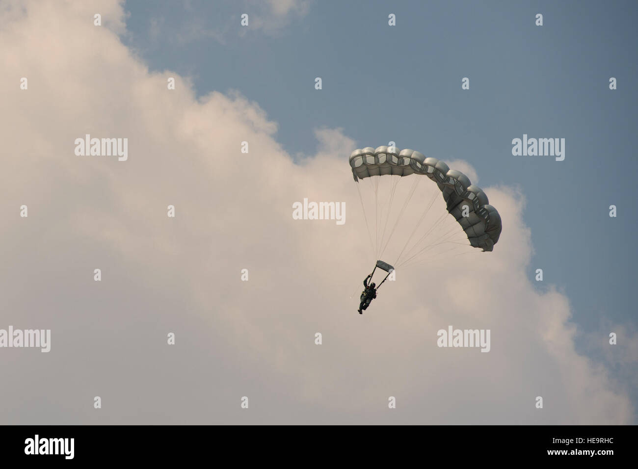 U.S. Air Force, Thai and Singaporean military conduct static and High Altitude Low Opening jumps from a U.S. C-130 during Exercise Cope Tiger 15 near Korat, Thailand, March 10, 2015. CT15 includes 22 total flying units and over 1,390 personnel from three countries and continues the growth of strong, interoperable and beneficial relationships within the Asia-Pacific region through integration of airborne and land-based command and control assets.  Airman 1st Class Taylor Queen Stock Photo