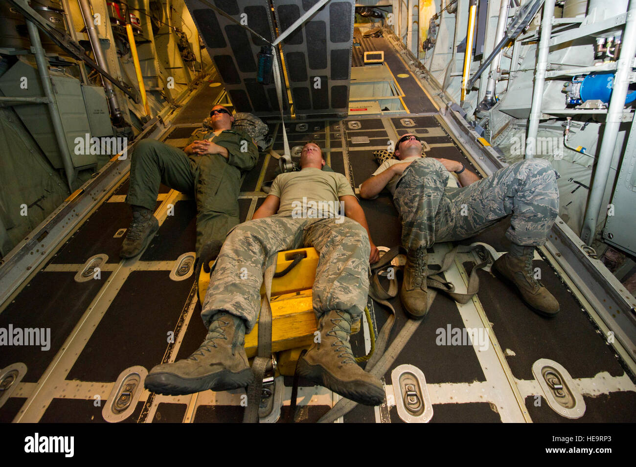 U.S. Air Force airmen sleep during a flight aboard a C-130H Hercules aircraft from the 731st Airlift Squadron, Peterson AFB, Colo., during a flight from Nevada Air National Guard Base Reno, to Fort Hunter-Liggett, Calif., on June 19, 2012 during Exercise GLOBAL MEDIC 2012.  Exercise GLOBAL MEDIC 2012 is a yearly joint field training exercise for theater aeromedical evacuation systems and ground medical components designed to replicate all aspects of combat medical service support.  Tech. Sgt. Erica J. Knight Stock Photo