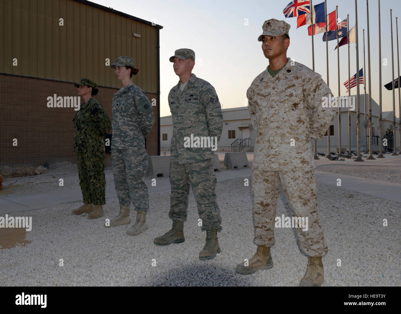 Service members representing the Army, Navy, Marine Corps and Air Force  participate in a prisoners of war and missing in action remembrance  ceremony at the 379th Air Expeditionary Wing in Southwest Asia,