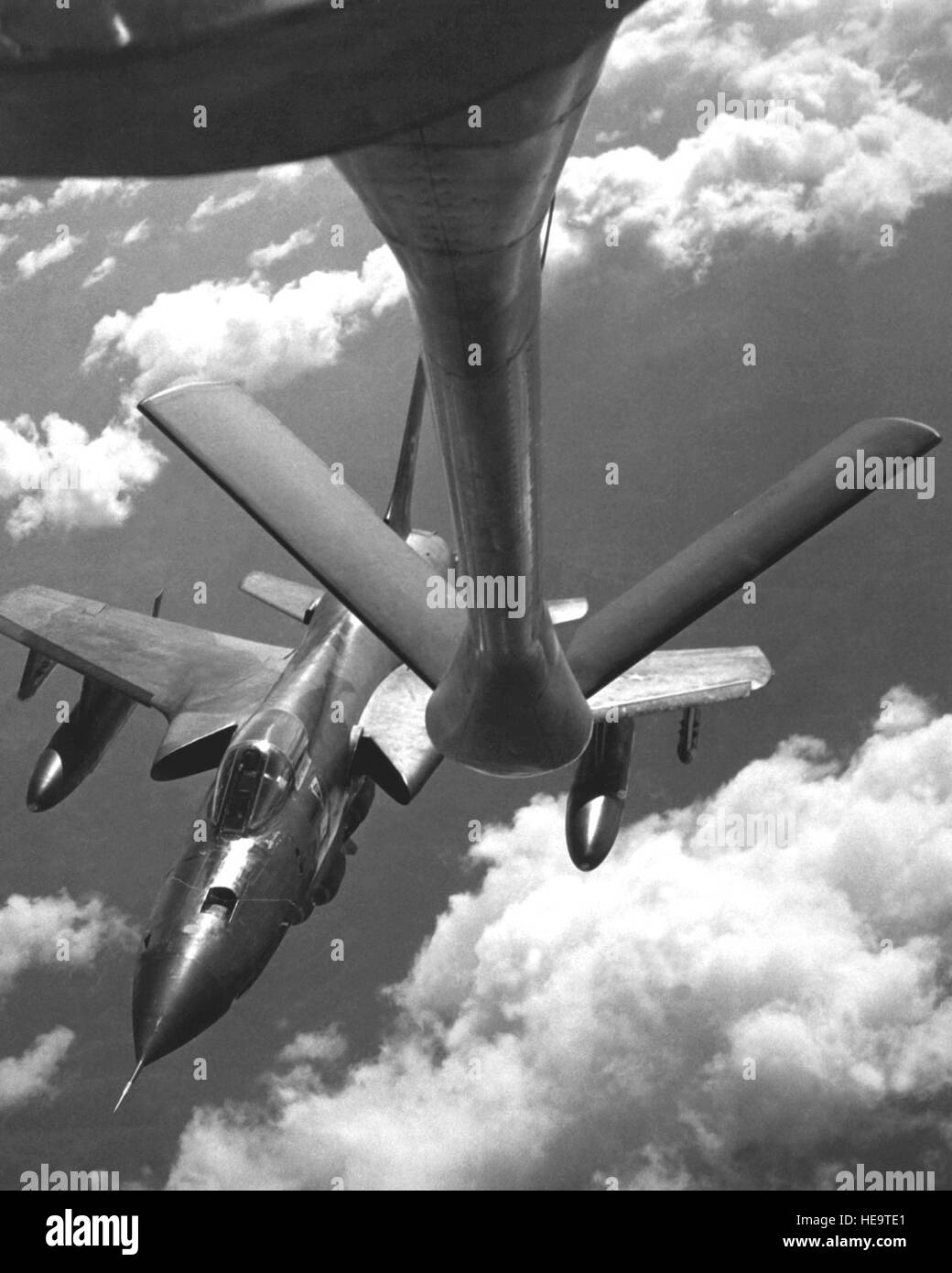 An air-to-air front view of an F-105D Thunderchief aircraft approaching a KC-135 Stratotanker aircraft for refueling during flight.  Aerial refueling and forward air control crews were honored by 388th Tactical Fighter Wing F-105D Thunderchief aircraft pilots in recognition of their successful coordinated combat mission.  The day of the combat was called 'Tanks a Million-That's a FAC' day. Stock Photo