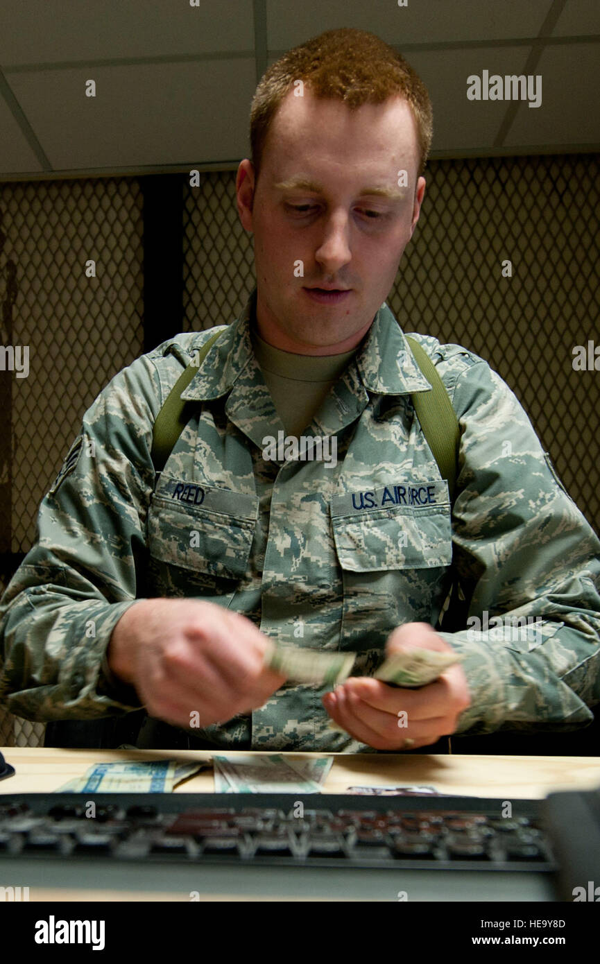 Senior Airman James Reed, 451st Air Expeditionary Wing finance cashier, counts Afghani at
