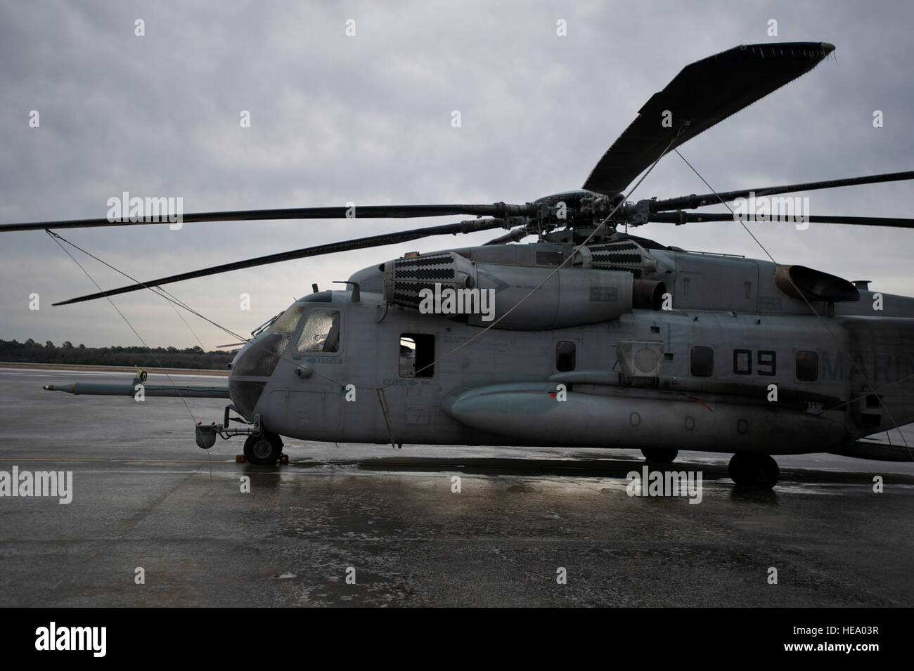 A U.S. Marine Corps CH-53 helicopter sits on the frozen flight line at Hurlburt Field, Fla., Jan. 29, 2014. The entire flight line was covered with a sheet of ice, and all aircraft were secured with chains. (U.S. Air Force Photo/ Staff Sgt. John Bainter) Stock Photo