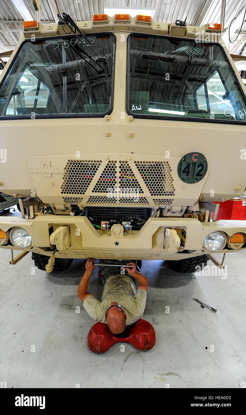 Staff Sgt. Matthew Di Terlizzi, 1st Special Operations Logistics Readiness Squadron vehicle maintenance specialist, unscrews a panel on a military truck at Hurlburt Field, Fla., April 28, 2014. The vehicle maintenance flight manages a fleet of approximately 600 base-wide vehicles and trains all vehicle control officers. Senior Airman Christopher Callaway) Stock Photo
