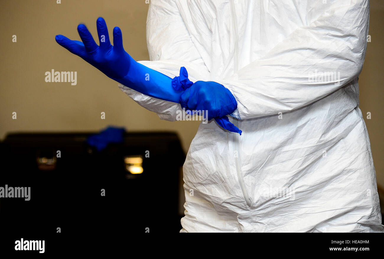 A U.S. Army Soldier practices donning personal protective equipment at Fort Eustis, Va., Oct. 15
