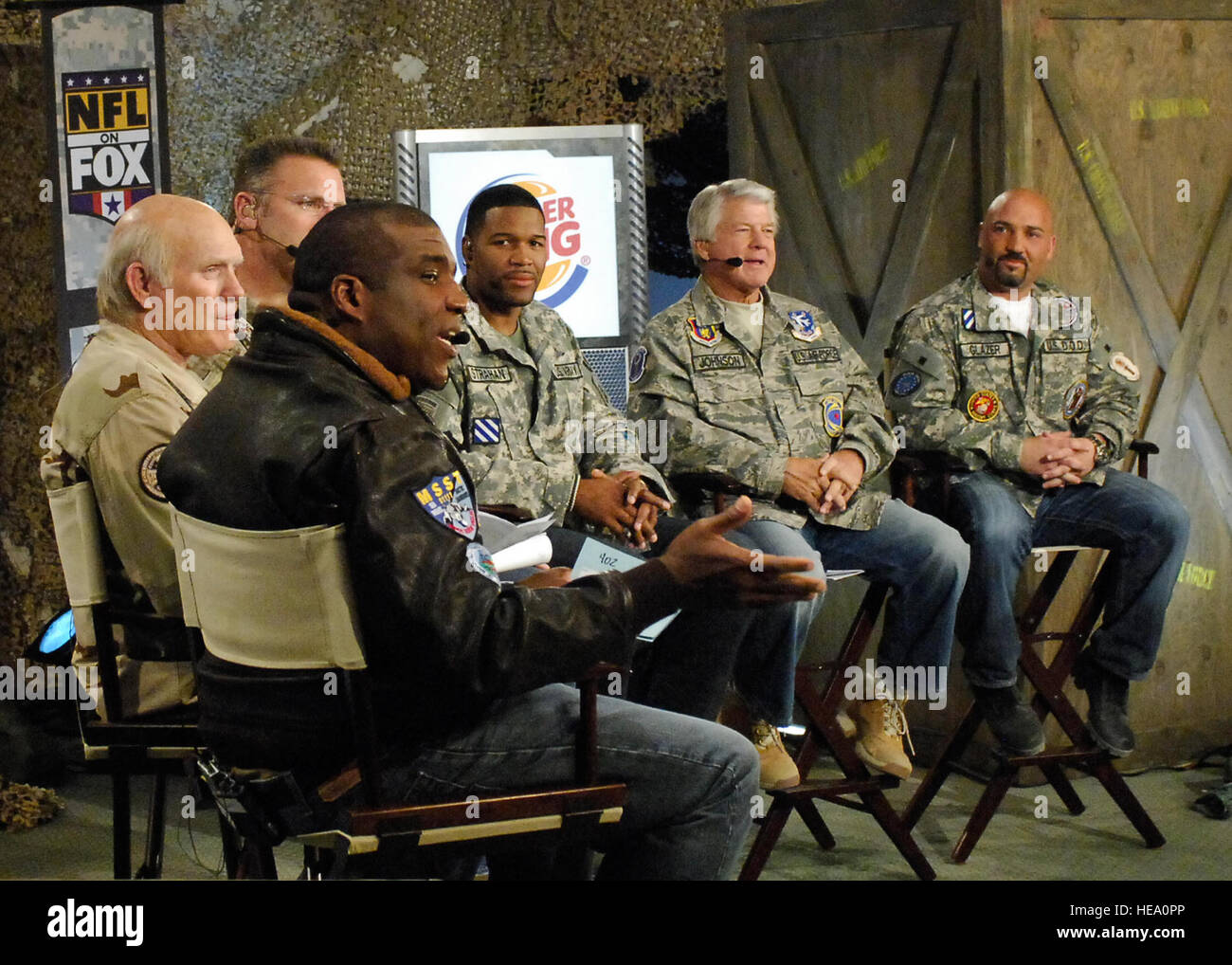 BAGRAM AIR FIELD, Afghanistan -- (From left to right) Curt Menefee, Terry Bradshaw, Howie Long, Michael Strahan, Jimmy Johnson, and Jay Glazer listen to questions during the pregame Nov. 7, 2009. The “Fox NFL Sunday” team came to visit Bagram to boost morale.  They are scheduled to broadcast live Nov. 8, 2009 from here.  Senior Airman Felicia Juenke) Stock Photo