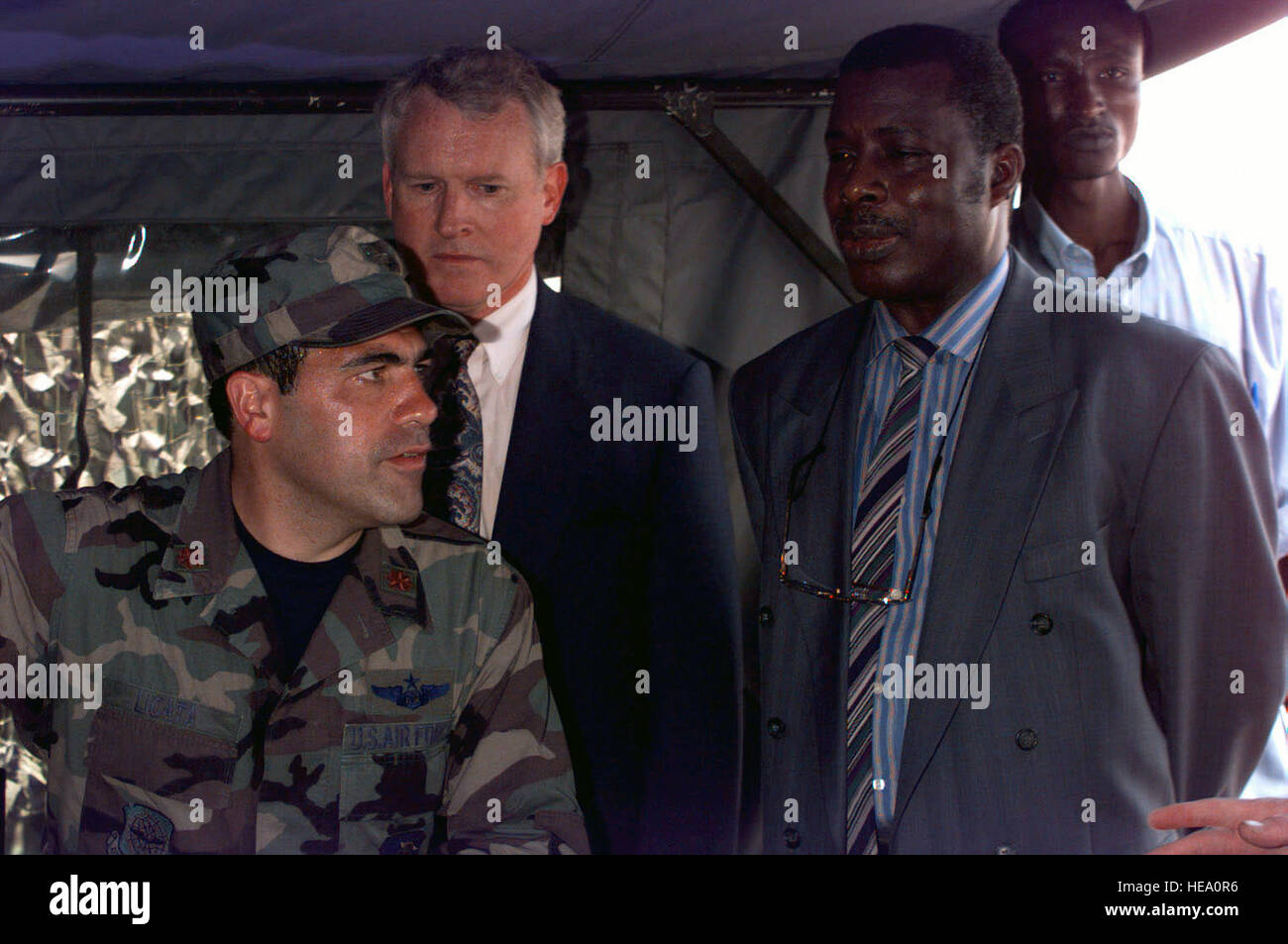 United States Air Force Major Mike Licata (left), 621st Tactical Airlift Control Element (TALCE) Commander explains his operations to members of the party accompanying Congolese Minister of Defense General (retired) Ayayen (right) during a tour of the operations center during Operation PHOENIX GAUNTLET.  PHOENIX GAUNTLET deployed enabling forces as part of contingency planning to prepare for a possible evacuation of Americans from Zaire, gripped in a civil war. Stock Photo