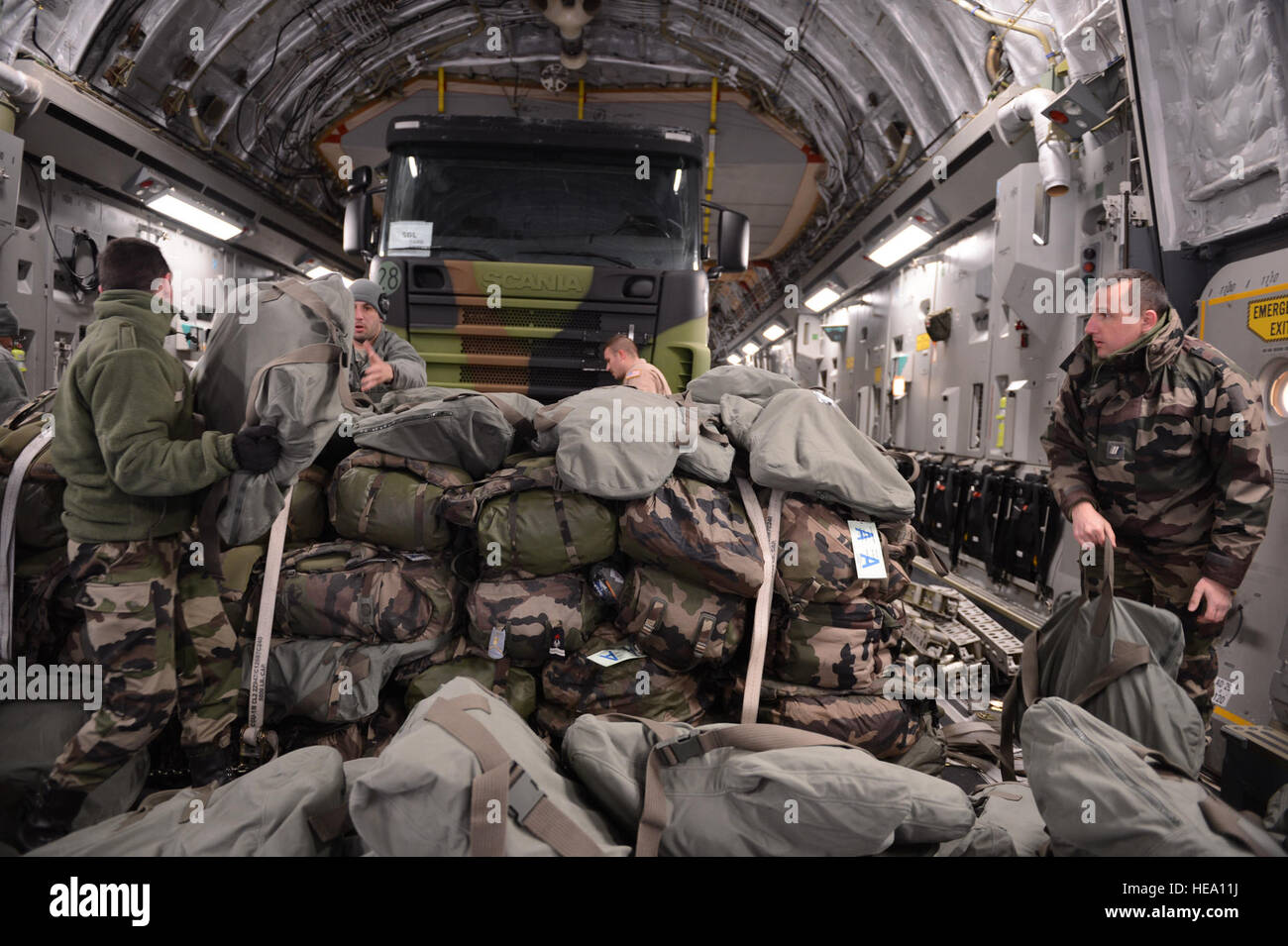 ISTRES, France – U.S. Airmen and French soldiers load equipment inside a  U.S. Air Force C-17 Globemaster III in Istres, France, Jan. 21, 2013. The  U.S. sent Airmen to France as logistical