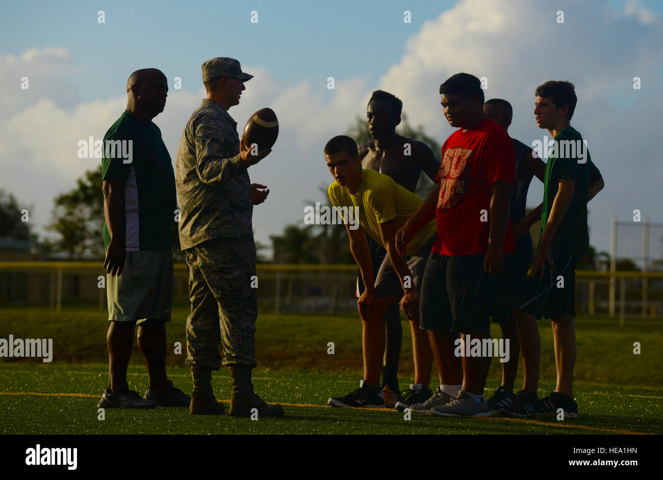 Jacob Dowdell, Guam High School head coach, left, supervises Senior Airman Presley Griffith, 36th Mobility Response Squadron executive assistant, second from left, as he teaches a free football spring practice camp June 8, at Andersen Air Force Base, Guam. Griffith hopes to someday become a high school football coach and volunteers his time to offer an additional pre-season training opportunity to local high school athletes.  Senior Airman Alexander W. Riedel Stock Photo