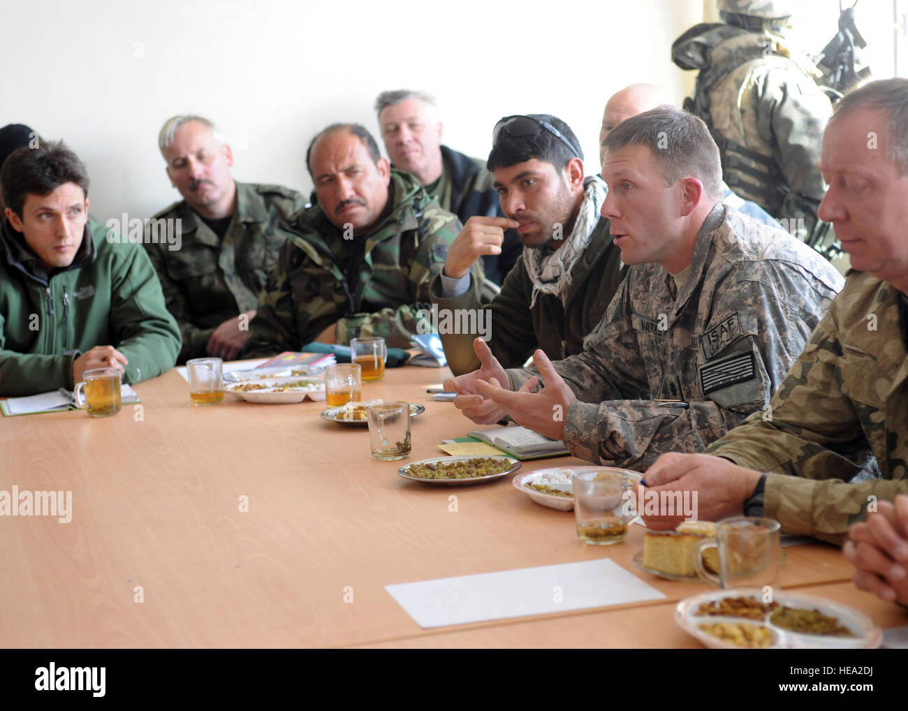 U.S. Navy Cmdr. Wilson Marks, Commanding Officer of Ghazni Provincial Reconstruction Team, discusses development and security at a shura held in the Moqur District Center in Ghazni Province, Jan 12. ISAF servicemembers, and leaders representing the Afghan National Army, Afghan National Police and subgovernors from the districts of Giro, Qara Bagh, Muqor and Gelan met to discuss ways to develop their districts while improving security.  U.S. Air Force Master Sgt. Sarah R. Webb, Ghazni Provincial Reconstruction Team Public Affairs) Stock Photo