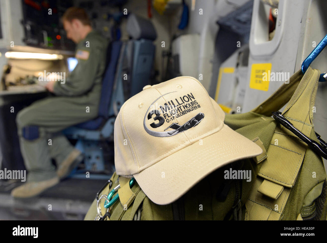 Captain Timothy Birt, 437th Airlift Wing, completes preflight checklists prior to a C-17’s departure to Joint Base Charleston S.C. The hat in the foreground was in recognition of the 3 millionth flying hour for the airframe. Officials from Robins, flight crews and distinguished visitors from Joint Base Charleston met at each base prior to the aircraft’s departure from Robins Air Force Base in a display of partnership and collaboration to celebrate the accomplishments of the men and women who played a part in making the aircraft a success around the globe.  Tommie Horton) Stock Photo
