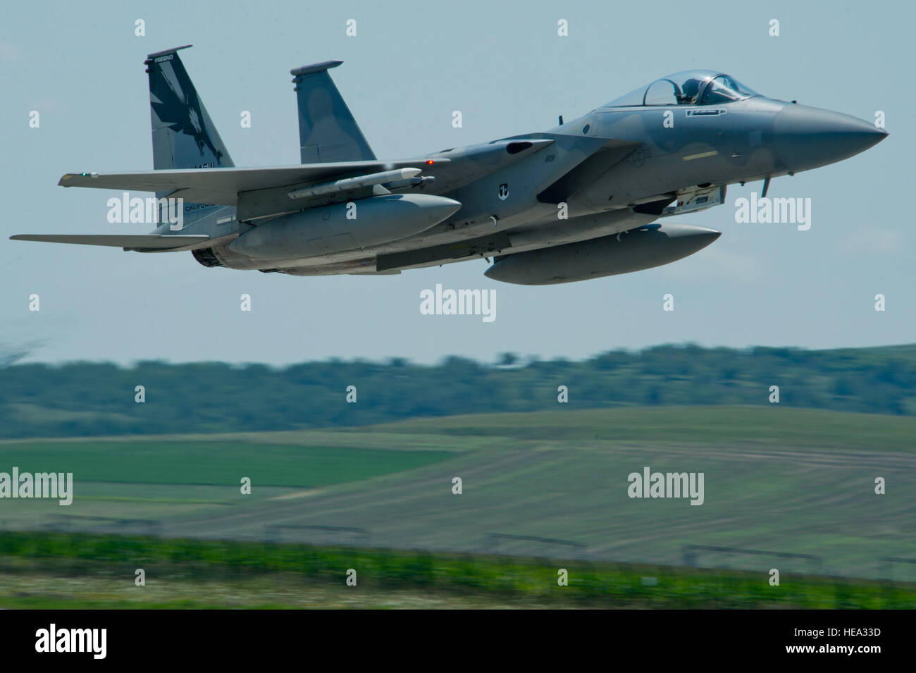 A California Air National Guard F-15C Eagle fighter aircraft assigned to the 194th Expeditionary Fighter Squadron, flies over the flightline during the Romanian air force's 71st Air Base's air show and open house at Campia Turzii, Romania, July 23, 2016. The aviation demonstration took place during the middle of the 194th EFS' six-month long theater security package deployment to Europe in support of Operation Atlantic Resolve, which aims to bolster the U.S.'s continued commitment to the collective security of NATO and dedication to the enduring peace and stability in the region. The unit, com Stock Photo