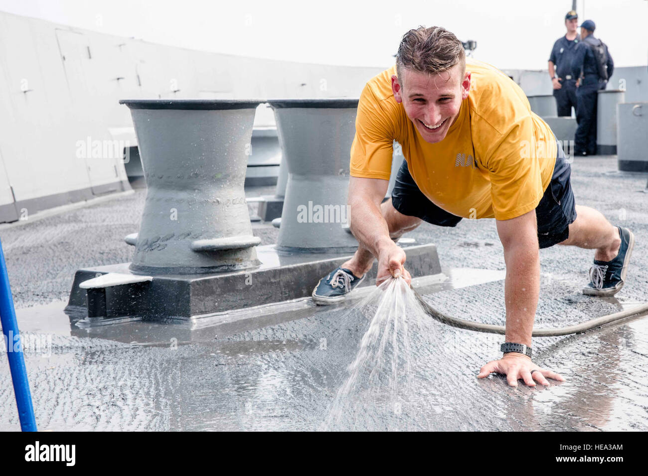 SASEBO, Japan (Aug. 4, 2016) Lt. Brennan Hosack sprays water on the forecastle of the amphibious transport dock ship USS Green Bay (LPD 20) during a freshwater wash-down. Green Bay is attached to the Bonhomme Richard Amphibious Ready Group and is currently underway conducting preparations for an upcoming deployment to the U.S. 7th Fleet area of operations.  Mass Communication Specialist 1st Class Chris Williamson Stock Photo
