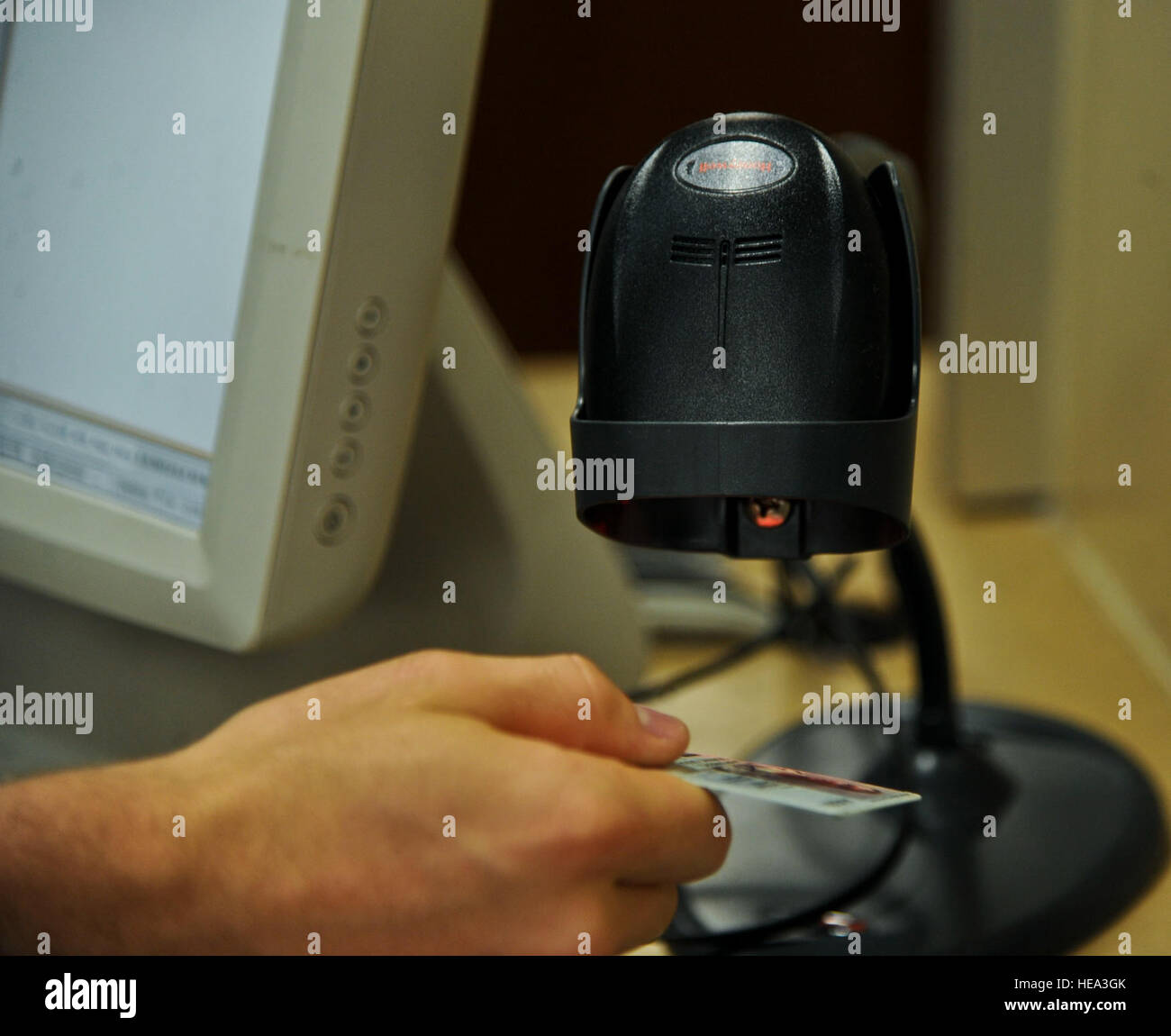 As a staff member scans a patient's identification card, a shelf within