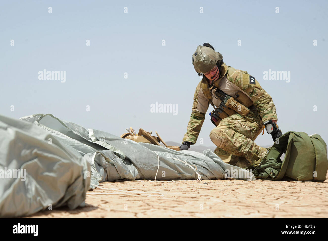 (090520-F-3682S-268) GRAND BARA, Djibouti (May 20, 2009) U.S. Air Force Senior Airman Michael Hagerman, a pararescueman from the 82nd Expeditionary Rescue Squadron (ERQS) packs his parachute after landing in the desert during a joint mass casualty exercise near Camp Lemonier. Guardian Angels from the 82nd worked alongside Marines from the 13th Marine Expeditionary Unit (MEU) to recover simulated isolated personnel in an austere environment.  Staff Sgt. Joseph L. Swafford Jr. Stock Photo