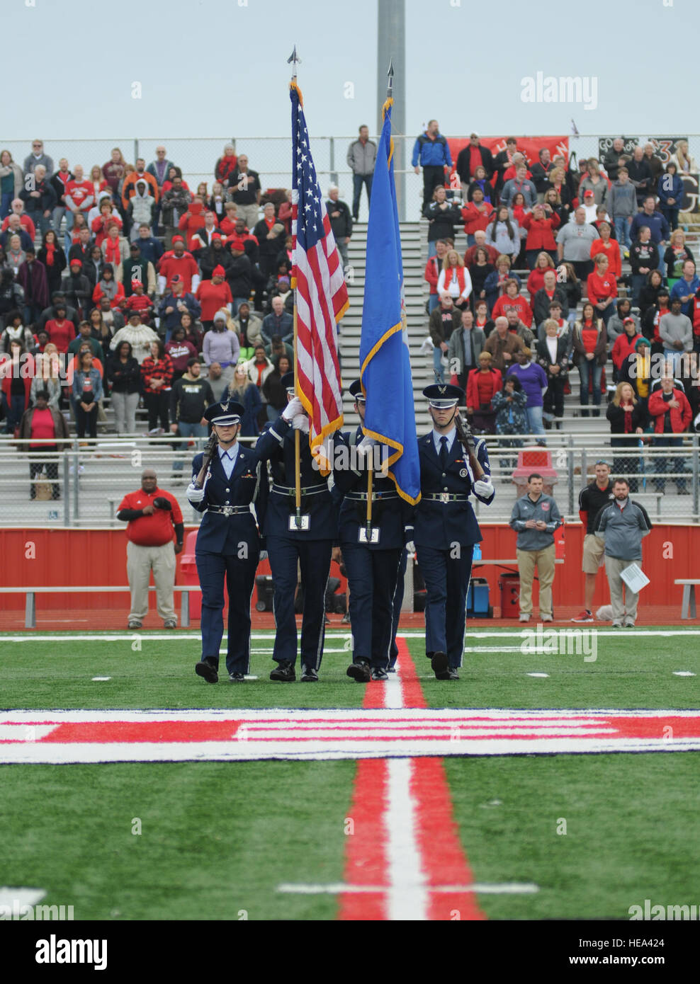 The Honor Guard with Keesler Air Force Base, Miss., marches onto the field in preparation of presenting the colors for the singing of the national anthem during a pregame celebration at the 2013 Mississippi Bowl at the Biloxi High School football stadium Dec. 8, 2013. Brig. Gen. Patrick Higby, 81st Training Wing commander, and Airmen carrying the 50 state flags also participated in the pregame celebration.  Kemberly Groue Stock Photo