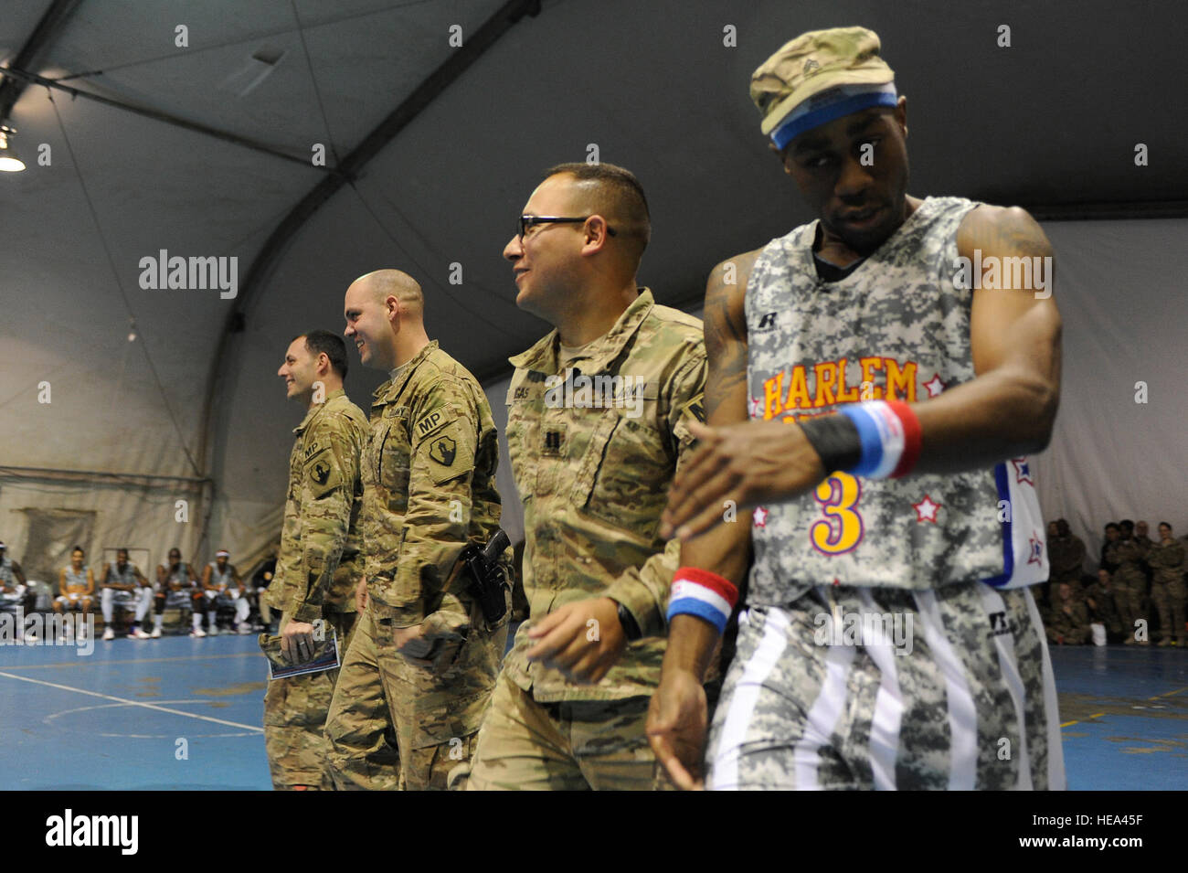 'Firefly' Fisher attempts to use the U.S. Army Military Police as camouflage to 'ambush' a fellow Globetrotter with water. The visit was the first for the Globetrotters to Afghanistan, making it the 121st country and territory the team visited.  Master Sgt. Jun Kim) Stock Photo