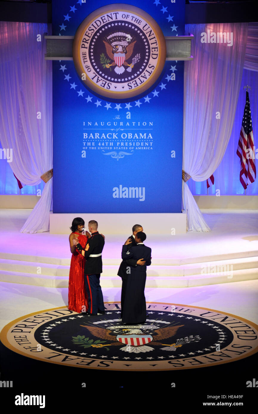 President Barack Obama and his wife, First Lady Michelle Obama dance with Staff Sgt. Bria Nelson, 579th Medical Operations Squadron, Joint Base Anacostia-Bolling, Washington, D.C., and Gunnery Sgt. Timothy Easterling, Marine Barracks, Washington, D.C., during the 2013 Commander in Chief inaugural ball at the Walter E. Washington Convention Center in Washington D.C., Jan. 21, 2013.  Throughout the 57th Presidential Inauguration, the Obama and Biden families have taken the opportunity to highlight the spirit of service and selflessness seen everyday U.S. military men, women and their families.   Stock Photo
